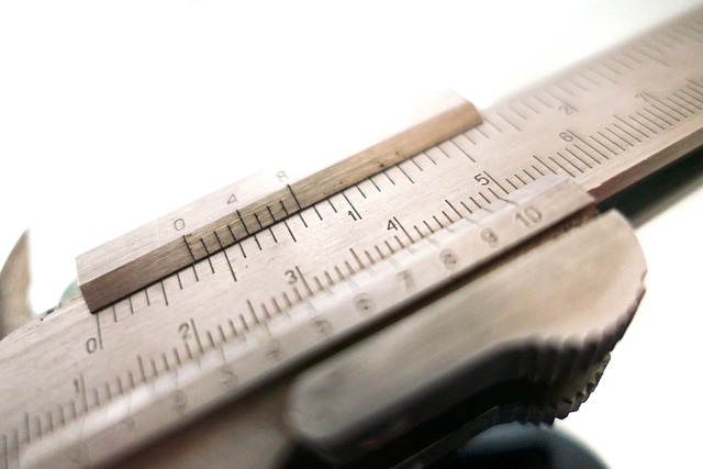 precision seam ripper tool close-up on fabric sewing workspace